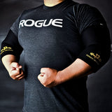 Athlete flexing while wearing Power Dragon elbow sleeves, showcasing support and sleek design